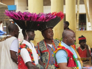 Members of a Yemba literacy class wearing traditional hats for the dance that will accompany the entry of the New Testament
